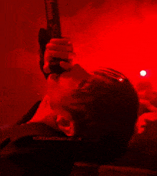 a close up of a person holding a microphone with the word kor in the corner