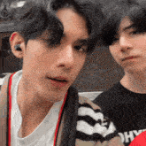 a close up of a man 's face next to another man wearing a black shirt that says " ohy "