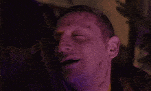 a close up of a man 's face with blood on his face