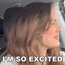 a woman in a car with the words i 'm so excited on the screen