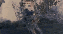 a man in a military uniform is walking down a street .