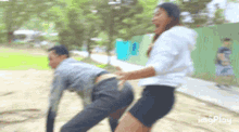 a blurry picture of a man and a woman with the words imgplay on the bottom right