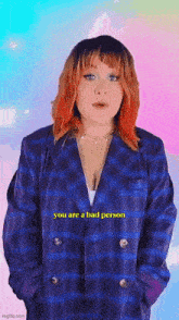 a woman with red hair is wearing a plaid jacket and a necklace and says you are a bad person .
