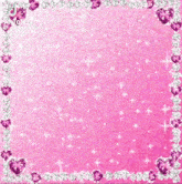 ariana grande is standing in front of a pink background with hearts and rhinestones .