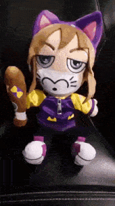 a stuffed animal wearing a mask is holding a bat