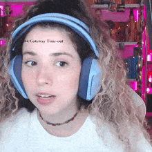 a woman wearing blue headphones has a tattoo on her face that says 04 gateway time-out