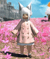 a little girl in a pink coat stands in a field of pink flowers with a castle in the background