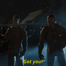a group of soldiers are standing in a dark room and one of them is saying got you