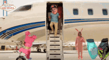 a welcome to las vegas sign is behind a man getting off an airplane