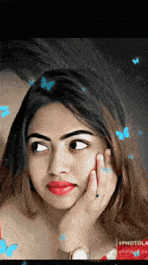 a photo of a woman with butterflies flying around her face