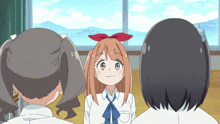 a girl with a red bow in her hair is surrounded by two other girls