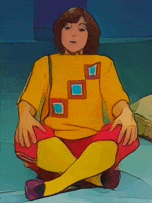 a girl in a yellow sweater and red pants sits on the floor