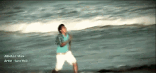 a man is standing on a beach with the name sunnyboi on the bottom right