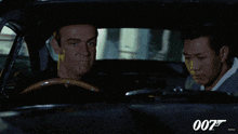 two men in a car with 007 on the bottom