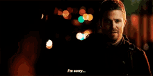 a man is standing in the dark and saying `` i 'm sorry `` .