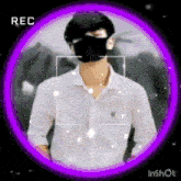 a man wearing a black mask and a white shirt is standing in a purple circle .