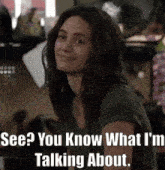 a woman in a green shirt is smiling and says " see you know what i 'm talking about "
