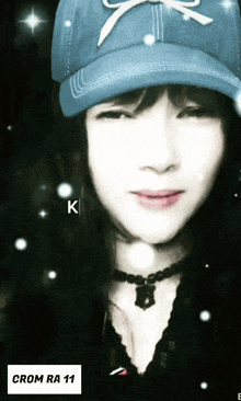 a woman wearing a blue hat with a bow on it and the words crom ra 11 below her