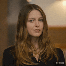 a close up of a woman 's face with a netflix logo in the background