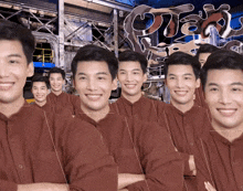 a group of men are smiling in front of a sign that says ' o'jay ' on it