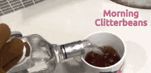 a bottle of water is being poured into a bowl with the words morning glitterbeans written on the bottom
