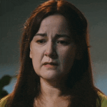 a close up of a woman 's face with her eyes closed