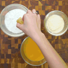 a person with a ring on their finger is holding a piece of food