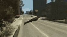 a person is flying through the air on a city street .