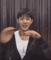 a young man wearing headphones and a black jacket is dancing