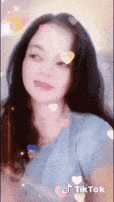 a woman 's face is covered in hearts and sparkles and says tiktok