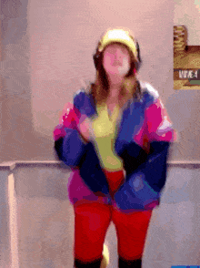 a blurry picture of a woman wearing headphones and a hat with the word vine on the wall behind her