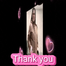a woman is standing in front of a sign that says " thank you "