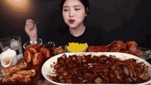 a woman is eating a large plate of food .