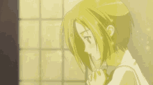 a girl with short blonde hair is holding her hand to her face