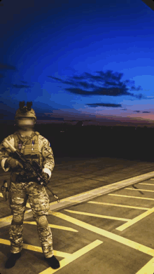a soldier stands in a parking lot at night