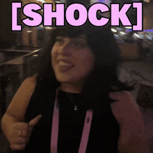 a woman is giving a thumbs up with the word shock behind her