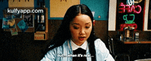 a woman is sitting at a table in a restaurant and saying but when it 's real