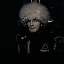 a man in a boxing ring with a monster energy sign in the background