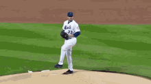 a baseball player with the number 33 on his jersey is about to throw the ball