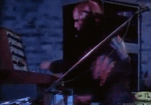 a man playing a violin in a dark room with the words nosmoking in the bottom right corner