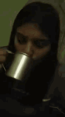 a close up of a woman drinking from a cup that says tfp on it