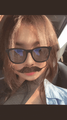 a girl wearing glasses and a fake mustache
