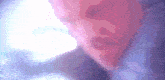 a close up of a person 's face with a purple and pink background