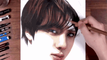 a person is drawing a portrait of a young man with a pencil