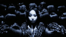 a black and white photo of a group of women with one wearing a shirt that says ' gucci ' on it
