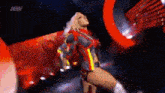 a woman in a superhero costume is standing on a stage .