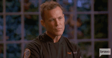 a man in a chef 's uniform with the word bravo on the bottom