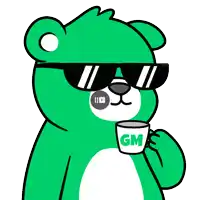 a green teddy bear wearing sunglasses is holding a cup with the letter gm on it
