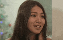 a close up of a woman 's face with a blurred background .