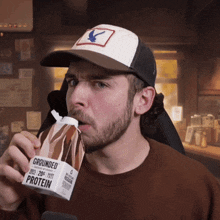 a man is drinking grounded protein from a box